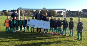 Photo of Lakenheath Youth Football accepting a grant cheque from Lakenheath Pride in Place
